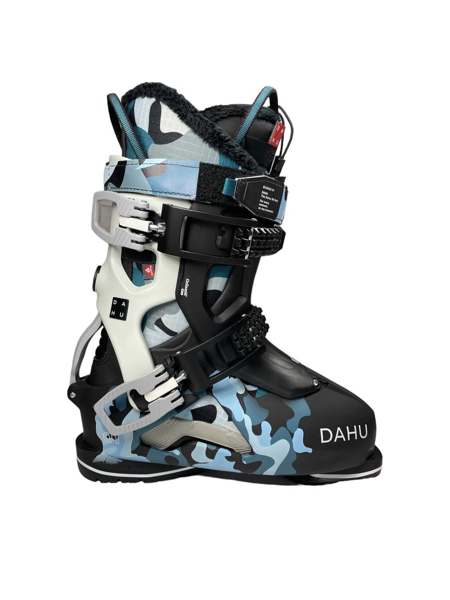 The Dahu Womens Ecorce 01 W110 Flex Ski Boot, in black, white, and blue camo with metal buckles and Primaloft insulation, stands upright against a white background—perfect for all-mountain skiers.