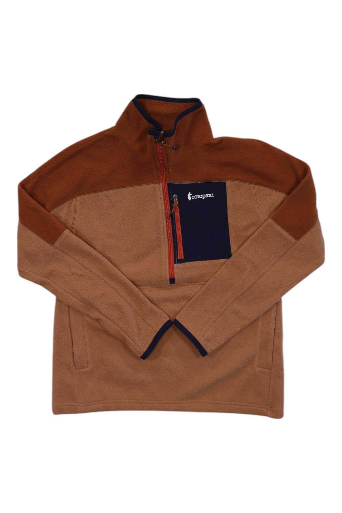 The Cotopaxi Womens Abrazo Half-Zip Fleece Jacket is a tan and brown fleece made from recycled polyester, featuring a half-zip, navy trim, zippered chest pocket, and Cotopaxi logo—a versatile choice for any adventure.