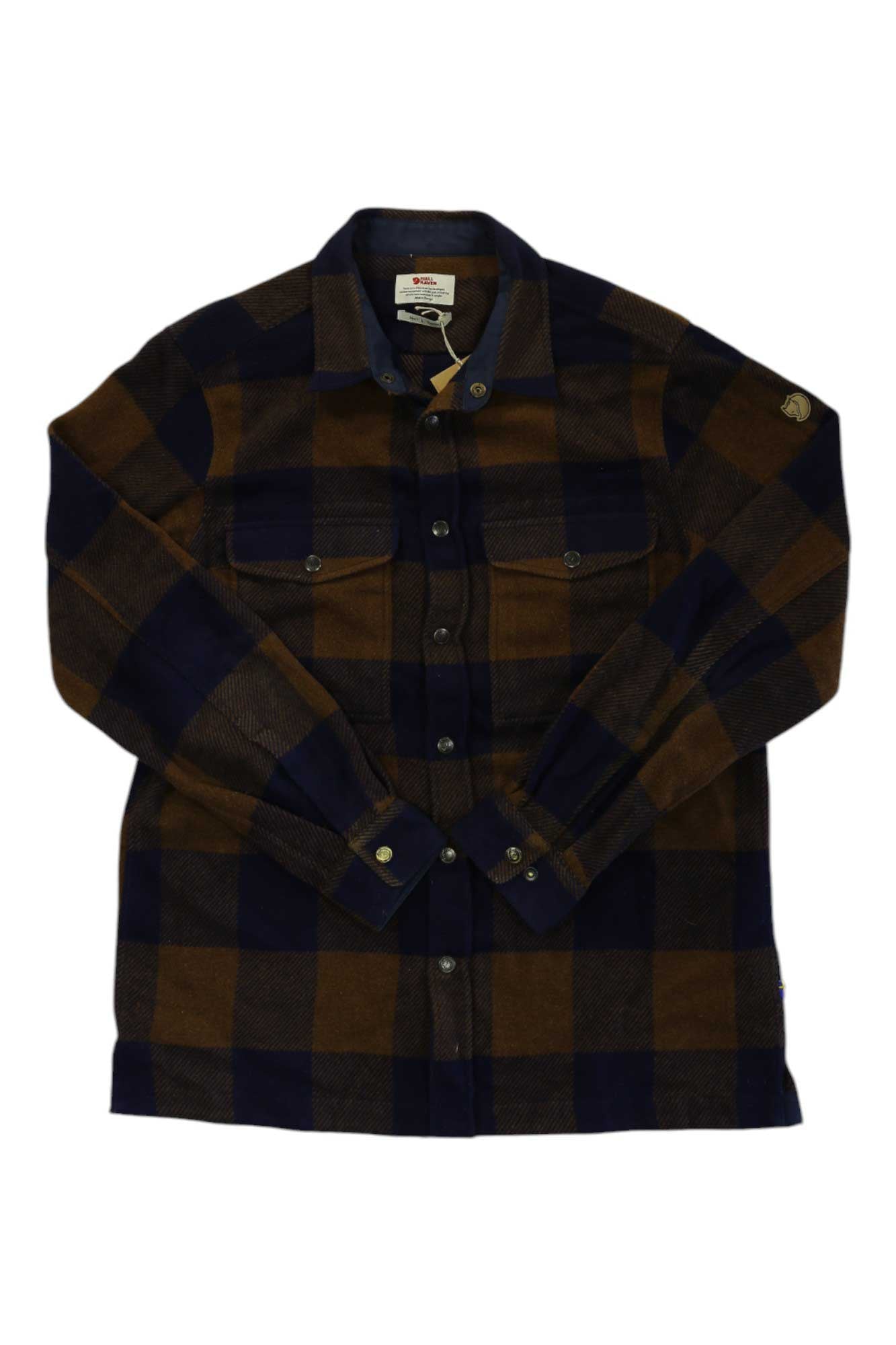 The Canada Shirt is a heavy wool, long-sleeve flannel with brown and navy plaid, button front, two chest pockets—ideal for casual travel. Shown laid flat on a white background.