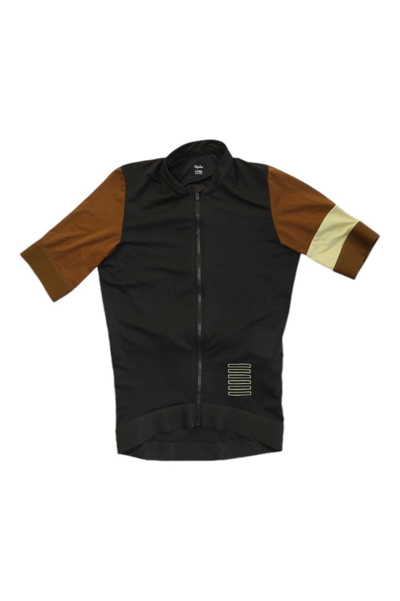 The Rapha Pro Team Training Jersey is short-sleeved with a black body, brown sleeves, and a beige left arm stripe. This performance cycling top has a front zipper and small horizontal stripes on the lower right side.