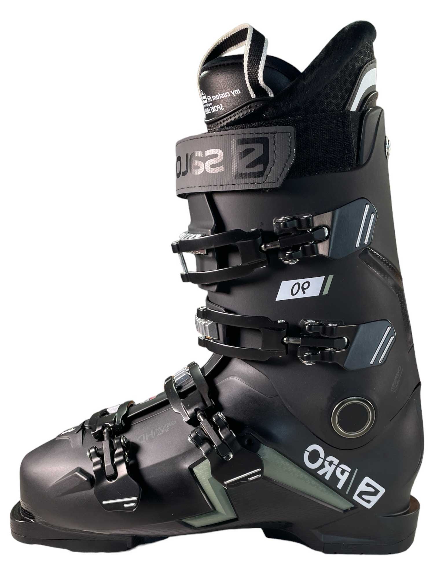 The Salomon S/Pro 90 Cs GW Mens Ski Boots feature a black design with metallic and white accents, four adjustable buckles, a top power strap, CustomShell fit, GripWalk technology, and SALOMON S/PRO branding on the side.