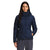 A woman with long dark hair wears The North Face Womens Metropolis Jacket, a hooded down coat with 550 fill goose down, standing facing forward with her hands in the pockets against a plain white background.