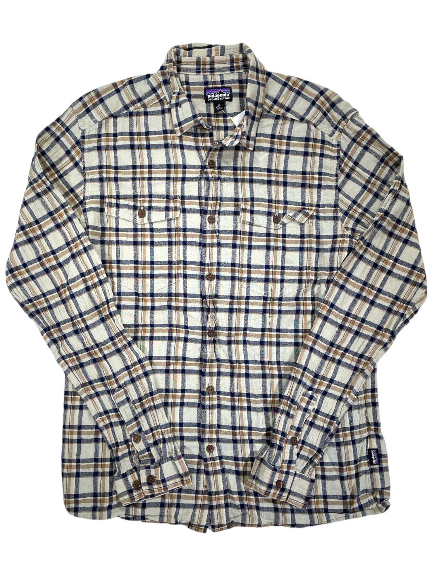 The Mens Long-Sleeved Steersman Shirt is a breathable, button-up plaid shirt in beige, blue, and brown checks, featuring two front chest pockets with button flaps and a collar for classic comfort and timeless style.
