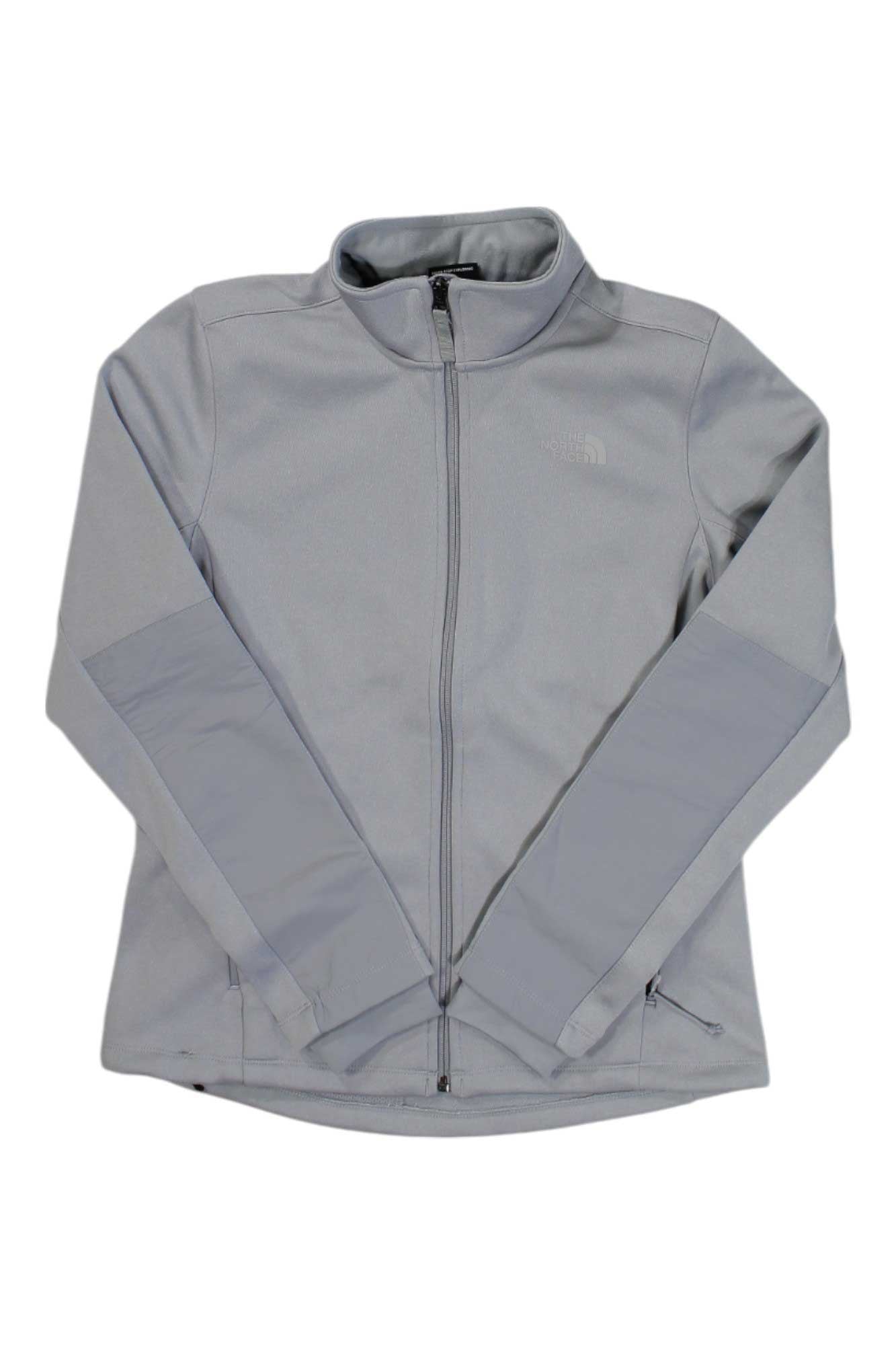 The North Face Womens Apex Quester Jacket in light gray, featuring long sleeves, a stand-up collar, and two side pockets, displayed flat on a white background.