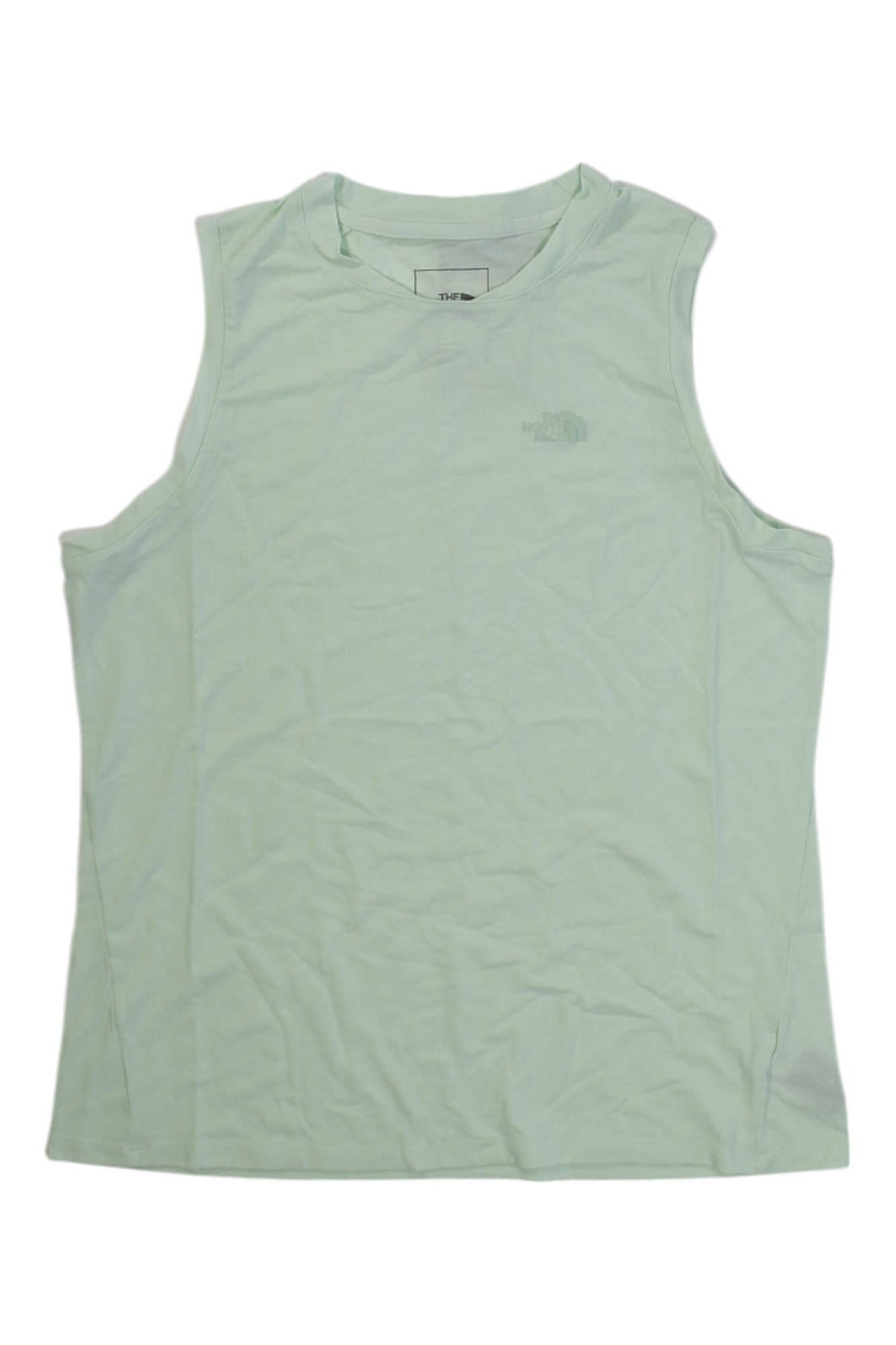 A Womens Wander Boxy Tank in light green is displayed flat on a white background. The slightly wrinkled fabric and chest logo highlight its design. This tank top offers moisture-wicking material for all-day comfort.