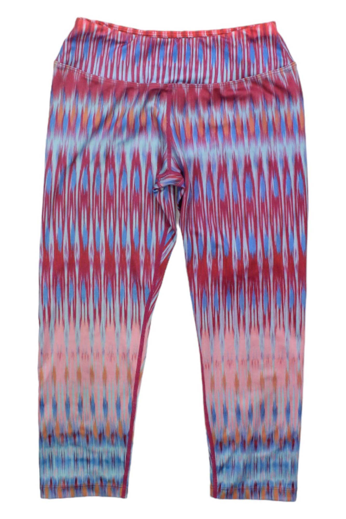 Womens Roxanne Capris feature a vibrant, symmetrical abstract print with vertical wavy lines on micropoly performance jersey. These ankle-length leggings offer a high waistband for top yoga performance and standout style.