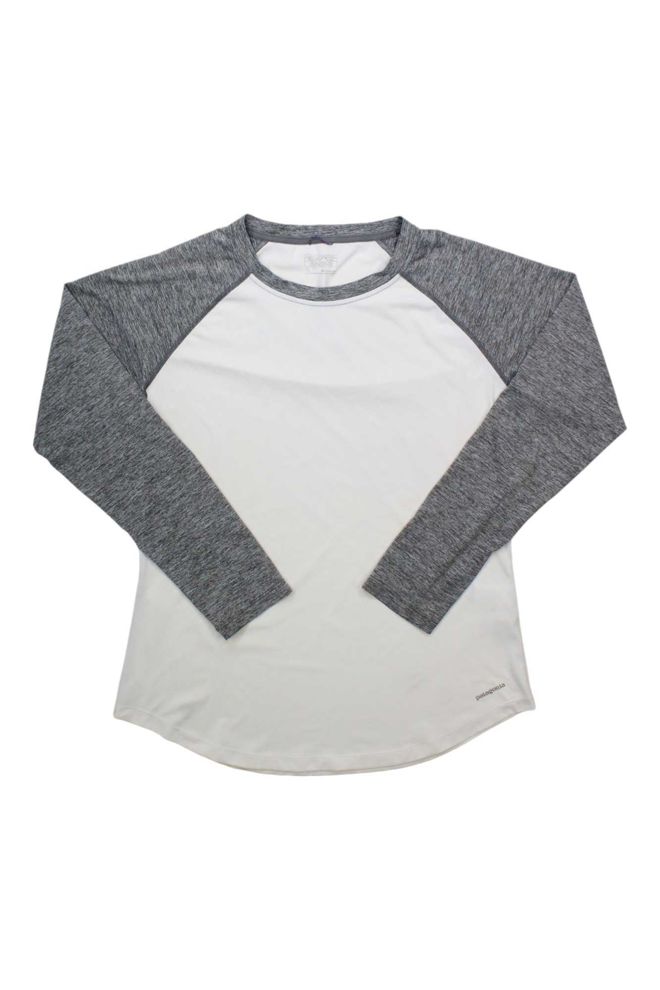 The Women's Tropic Comfort Crew is a long-sleeve raglan fly fishing shirt with heather gray sleeves and a white body, made from moisture-wicking fabric, shown laid flat on a white background.