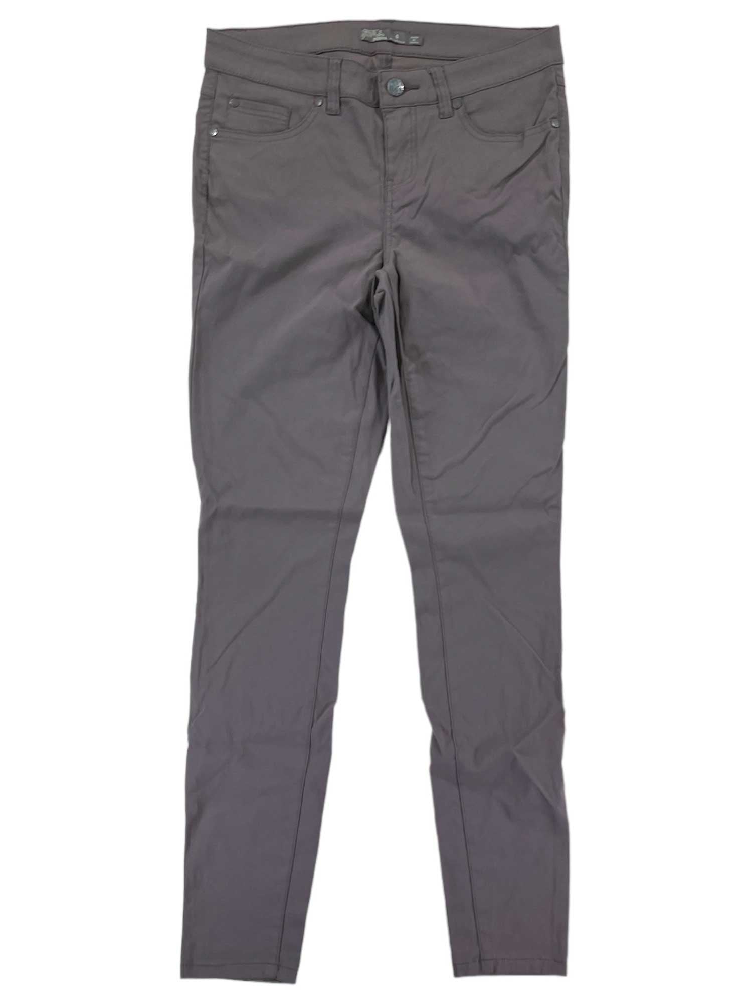 The Briann Pant is a gray, slim-fit, quick-drying skinny leg pant with button and zipper closure, front and back pockets, and belt loops, shown laid flat on a white background.