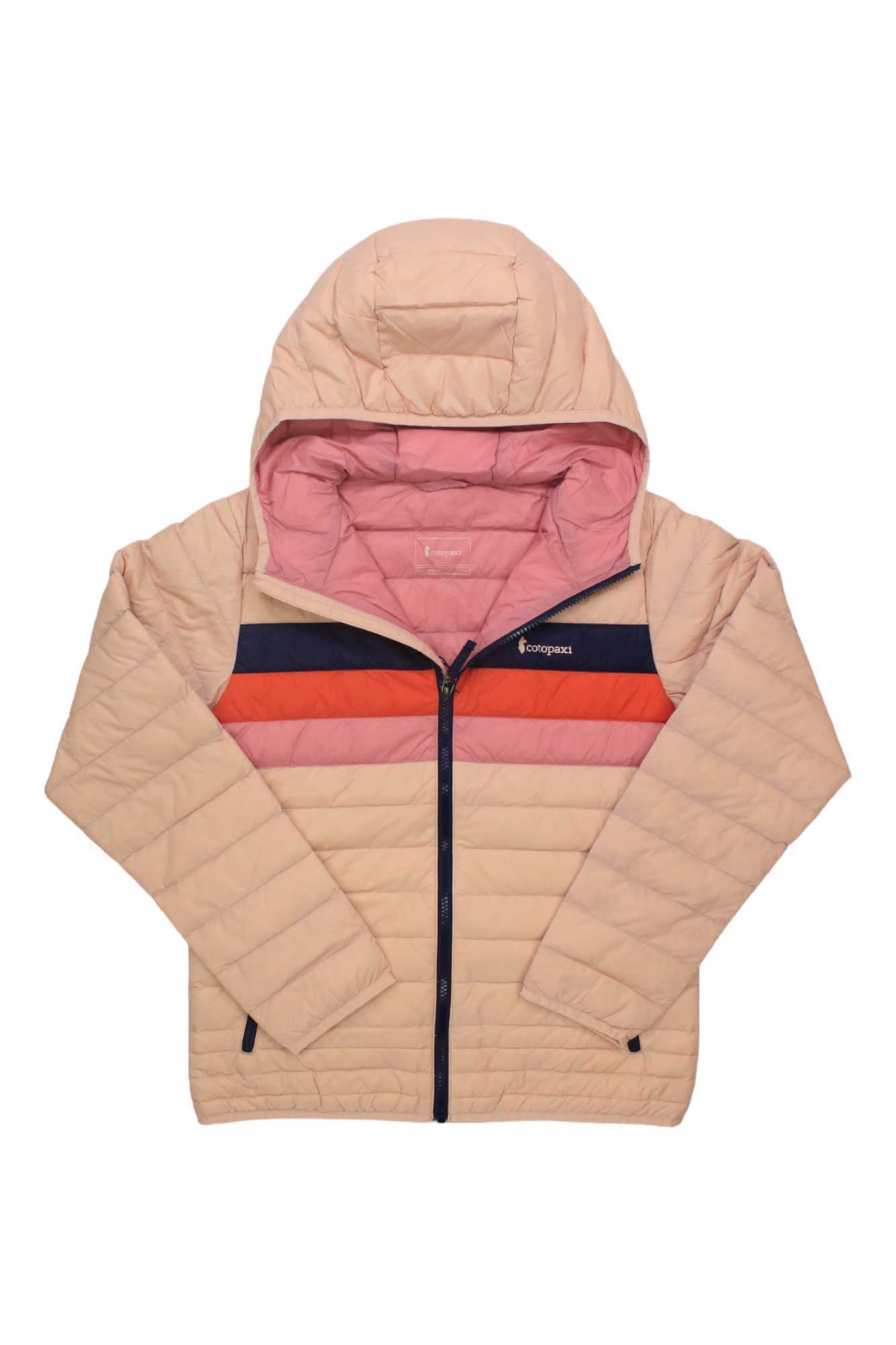 The Cotopaxi Kids Fuego Down Hooded Jacket is a light pink, packable jacket with a hood, navy blue and red chest stripes, front zipper, and long sleeves.