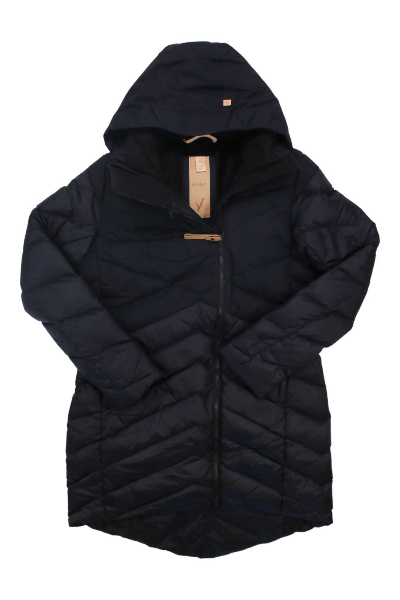 The Indyeva Women's Ayaba Mix II Jacket is a long, black quilted down jacket with a hood, zippered front, and tan collar tag, shown laid flat on a white background.