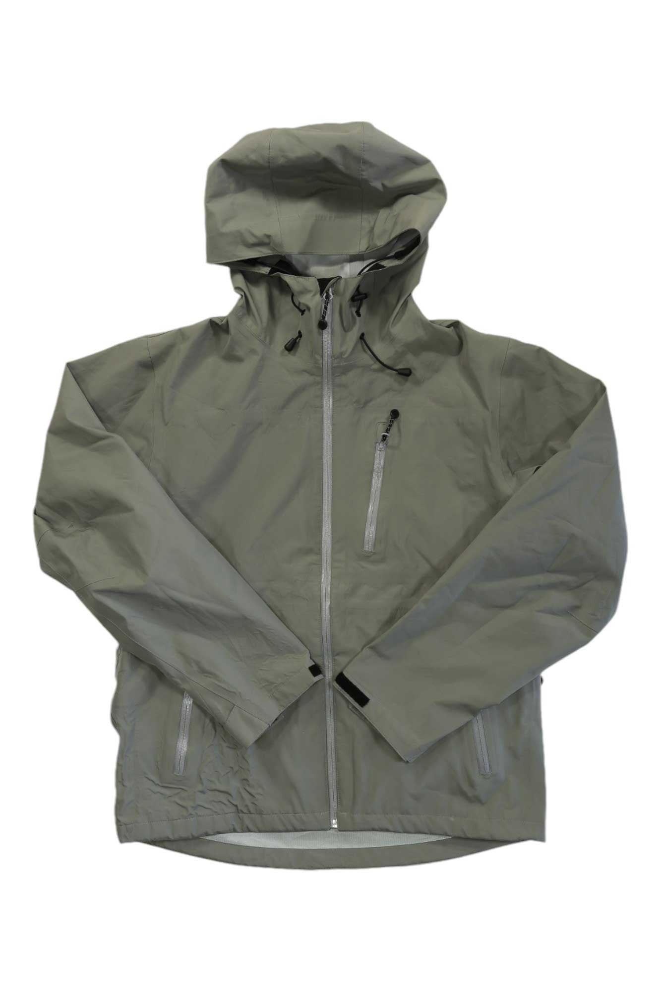 The Flylow Men’s Knight Jacket is a light grayish-green waterproof hardshell with a hood, front zipper, zippered chest pocket, and two zippered side pockets, shown laid flat on a white background.