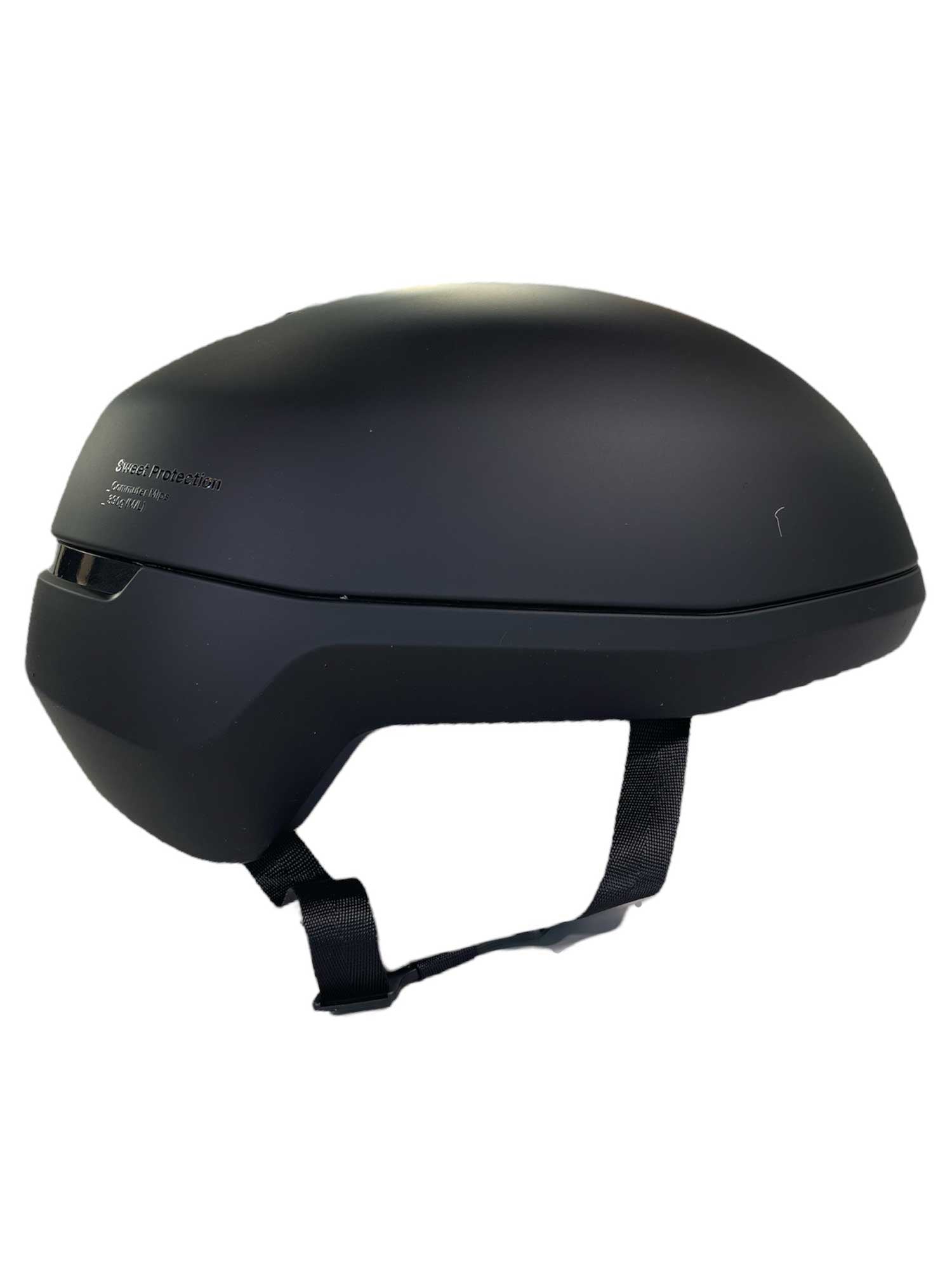 The Sweet Protection Men's Commuter MIPS Helmet features a matte black, rounded design with side ventilation slots and an adjustable strap—perfect for everyday rides.