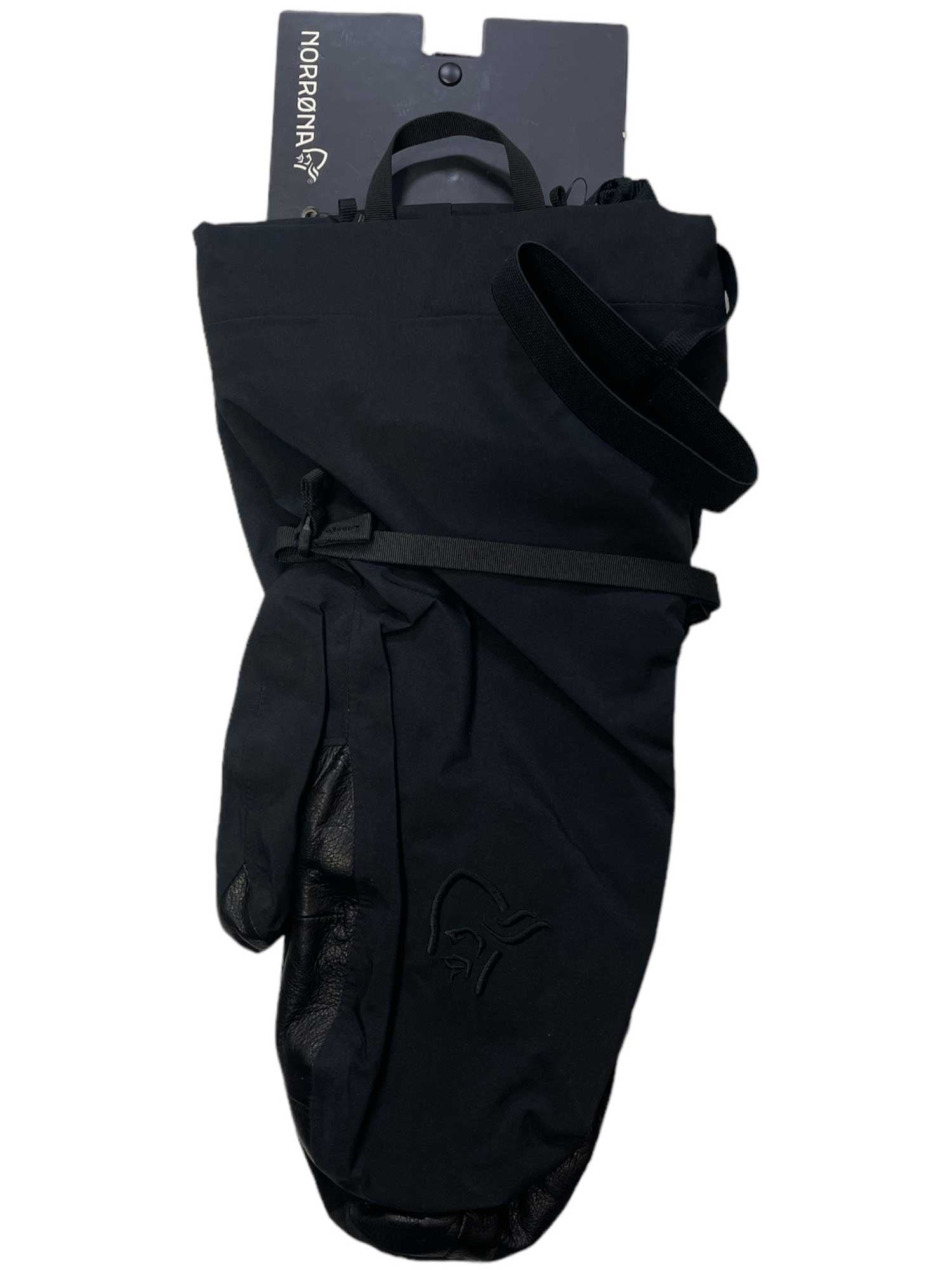 The Norrona Trollveggen Gore-Tex Pro Mitten is a single black alpine mitt with a leather palm and Norrona logo, attached to black packaging—perfect for mountaineering adventures.