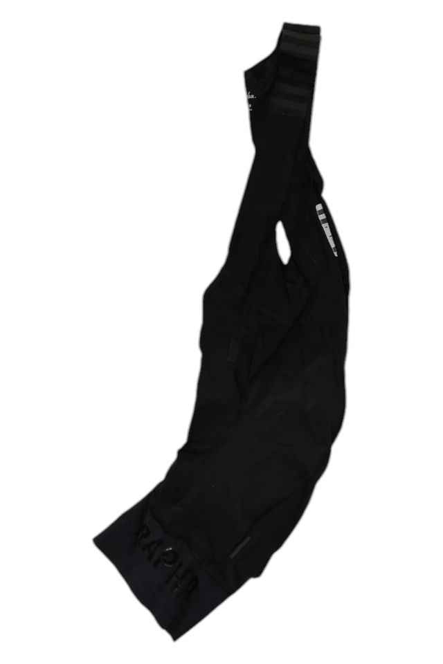 A pair of black Rapha Mens Pro Team Bib Shorts II - Regular with RAPHA branding on the leg, featuring a race-grade chamois, laid flat on a white background.