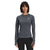 A woman wearing The North Face Womens Winter Warm Essential Crew long-sleeve shirt in dark gray and black leggings stands facing forward against a white background, carrying a sleek 30-liter backpack.