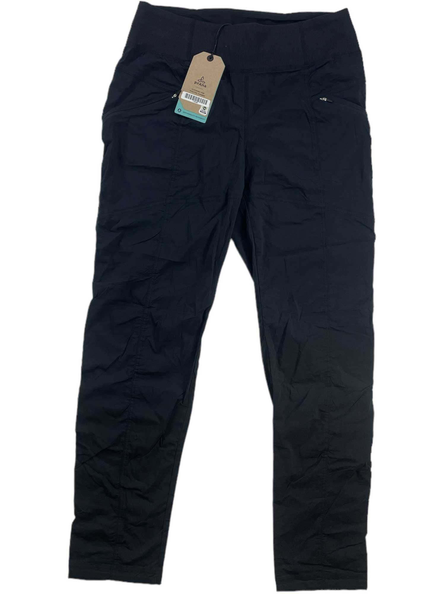 The Koen Pant is a pair of black, lightweight outdoor pants with a waistband, front pockets, and a brown tag near the waist. Displayed flat on a white background, these moisture-wicking pants keep you comfortable on the go.