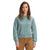 A woman with shoulder-length brown hair wears The North Face Womens Dunraven Crew Top in light teal fleece and brown pants, standing facing forward against a white background.