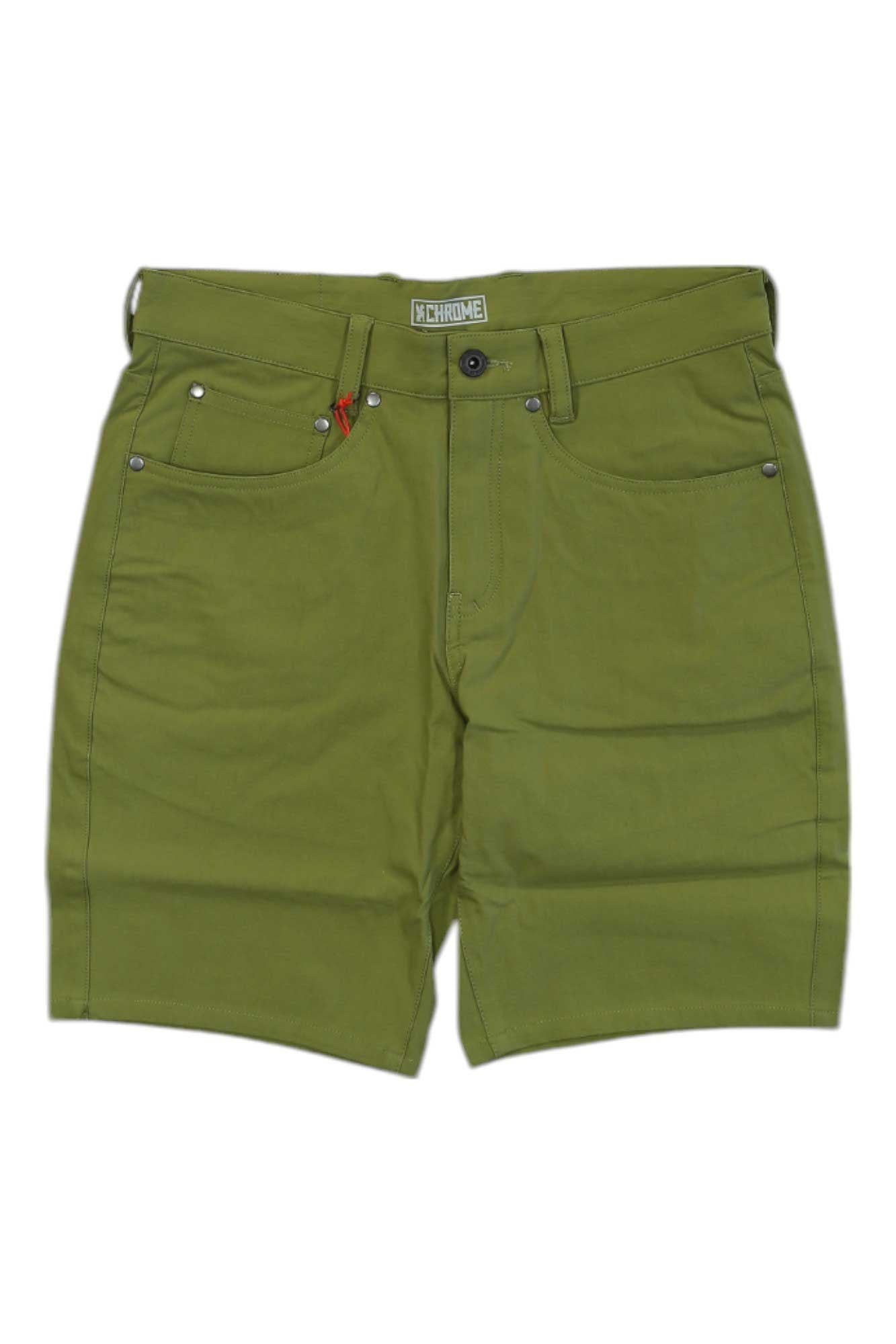 The Chrome Industries Mens Madrona Short features a green color, belt loops, front button and zipper, five pockets, visible seams, a small red tag on the front right pocket, and quick-dry comfort—ideal for commuters and everyday wear.