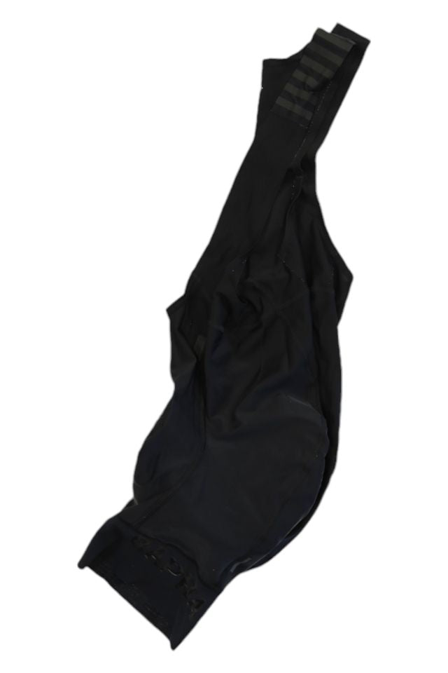 A pair of Rapha Mens Pro Team Bib Shorts II - Regular lies flat on a white background, showing the shoulder straps and race-grade chamois padding details.