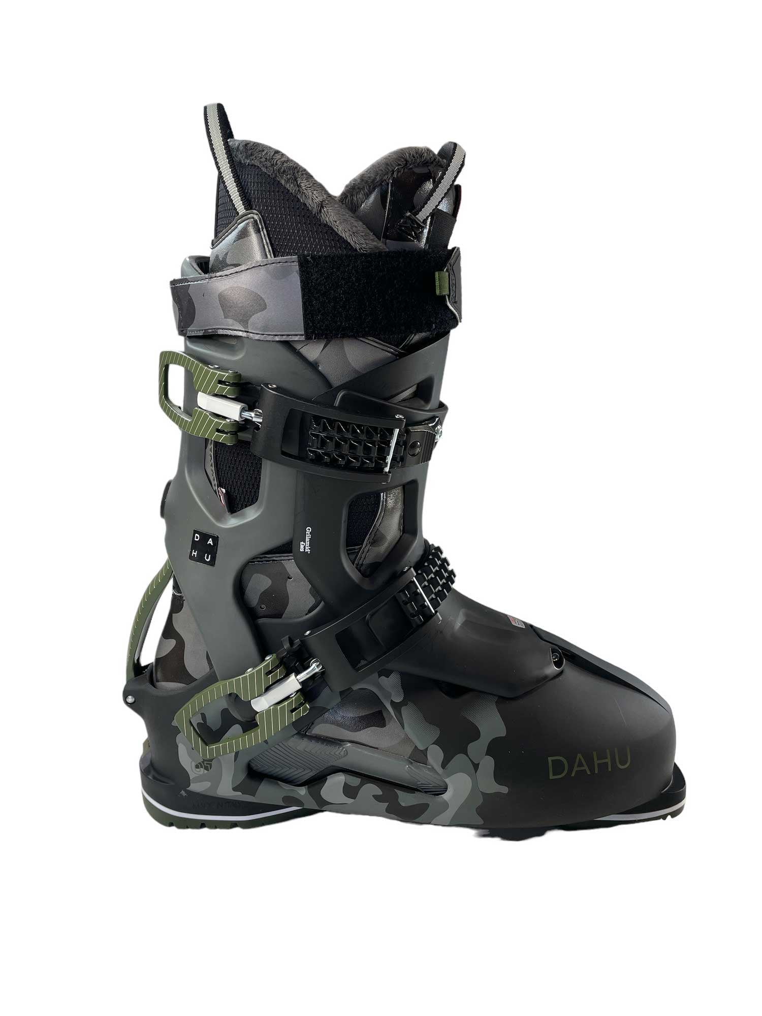 The Dahu Men's Ecorce 01 M120 Flex Ski Boot features a black and gray camo pattern, multiple adjustable buckles, “DAHU” branding by the toe, a soft Primaloft-insulated lining, and rugged design for all-mountain skiing comfort.
