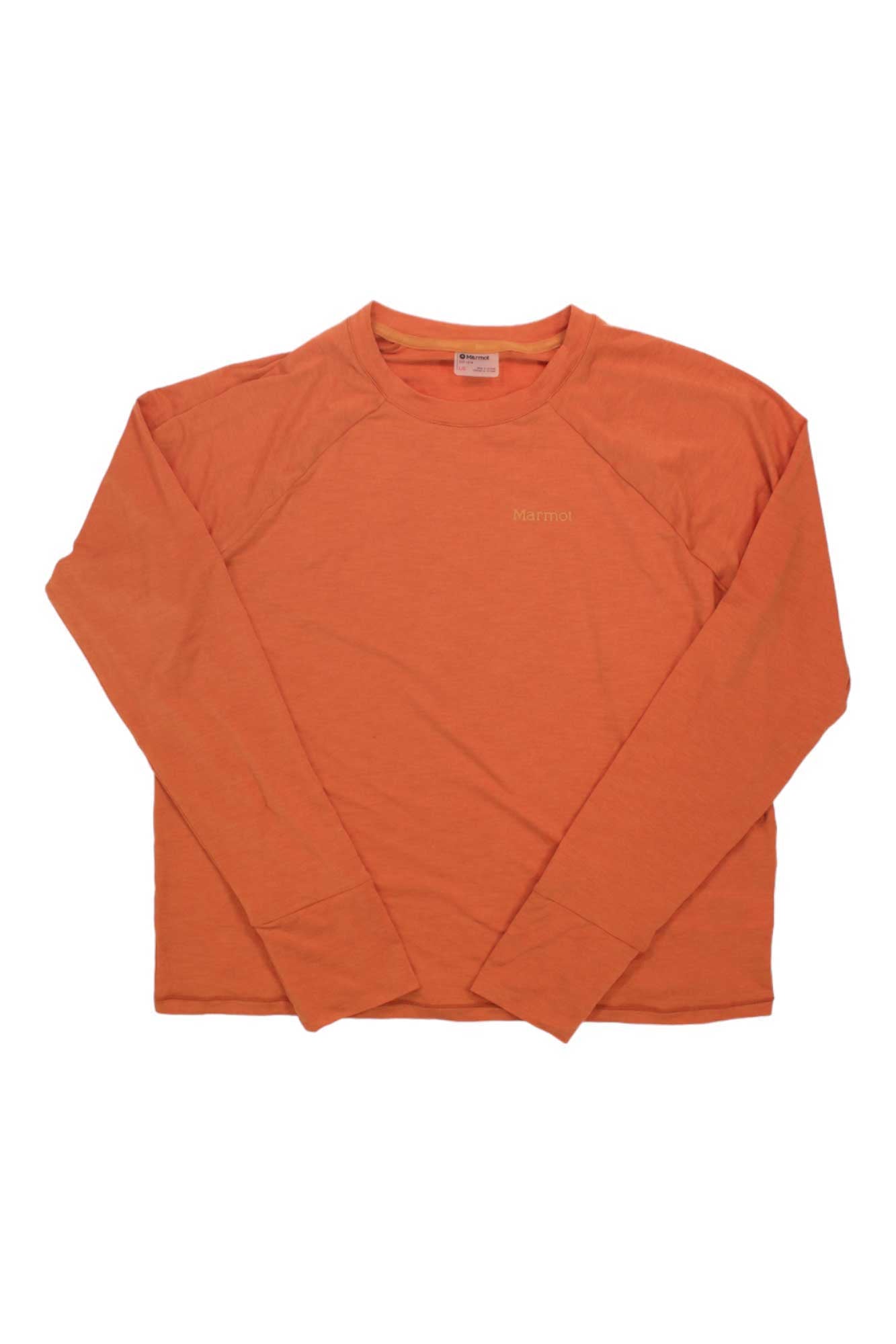 The Marmot Women's Mariposa LS Top, shown in orange with a crewneck and long sleeves, is laid flat on a white background. This ultra-lightweight hiking shirt offers a relaxed fit, odor management, subtle seam details, and chest embroidery.