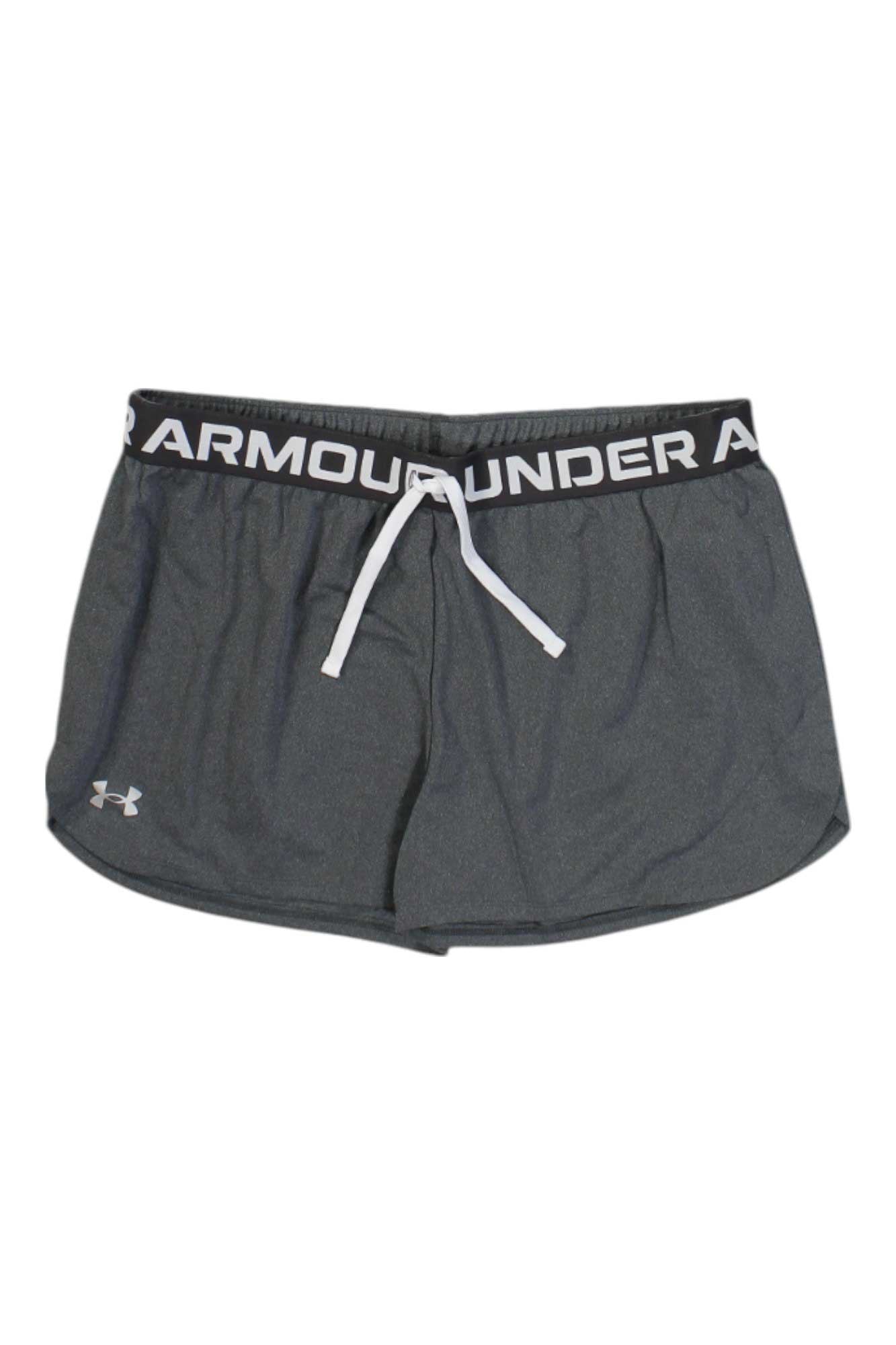 The Under Armour Girl's Play Up Solid Shorts are dark gray athletic shorts with an elastic waistband featuring the brand name in white, a white drawstring, and a small white logo. Moisture-wicking fabric keeps you cool and comfortable.