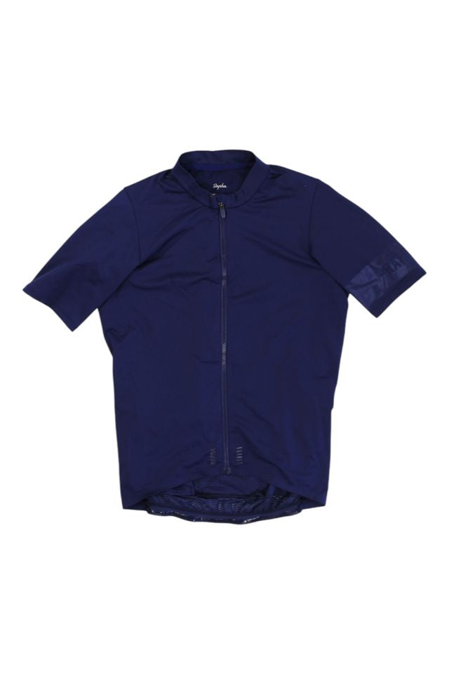 The Mens Pro Team Midweight Short Sleeve Jersey is shown in navy blue with a full front zipper, extended back hem, and a subtle left sleeve logo. The men's cycling jersey is displayed flat on a white background.