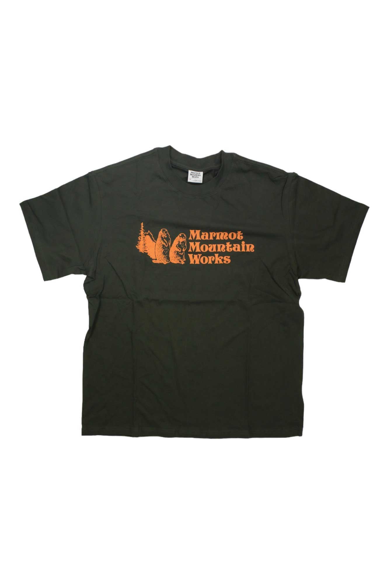 The Marmot Mens MMW Heavyweight SS Tee is a dark green short sleeve shirt featuring an orange “Marmot Mountain Works” logo and mountain graphic on the chest, shown laid flat on a white background.