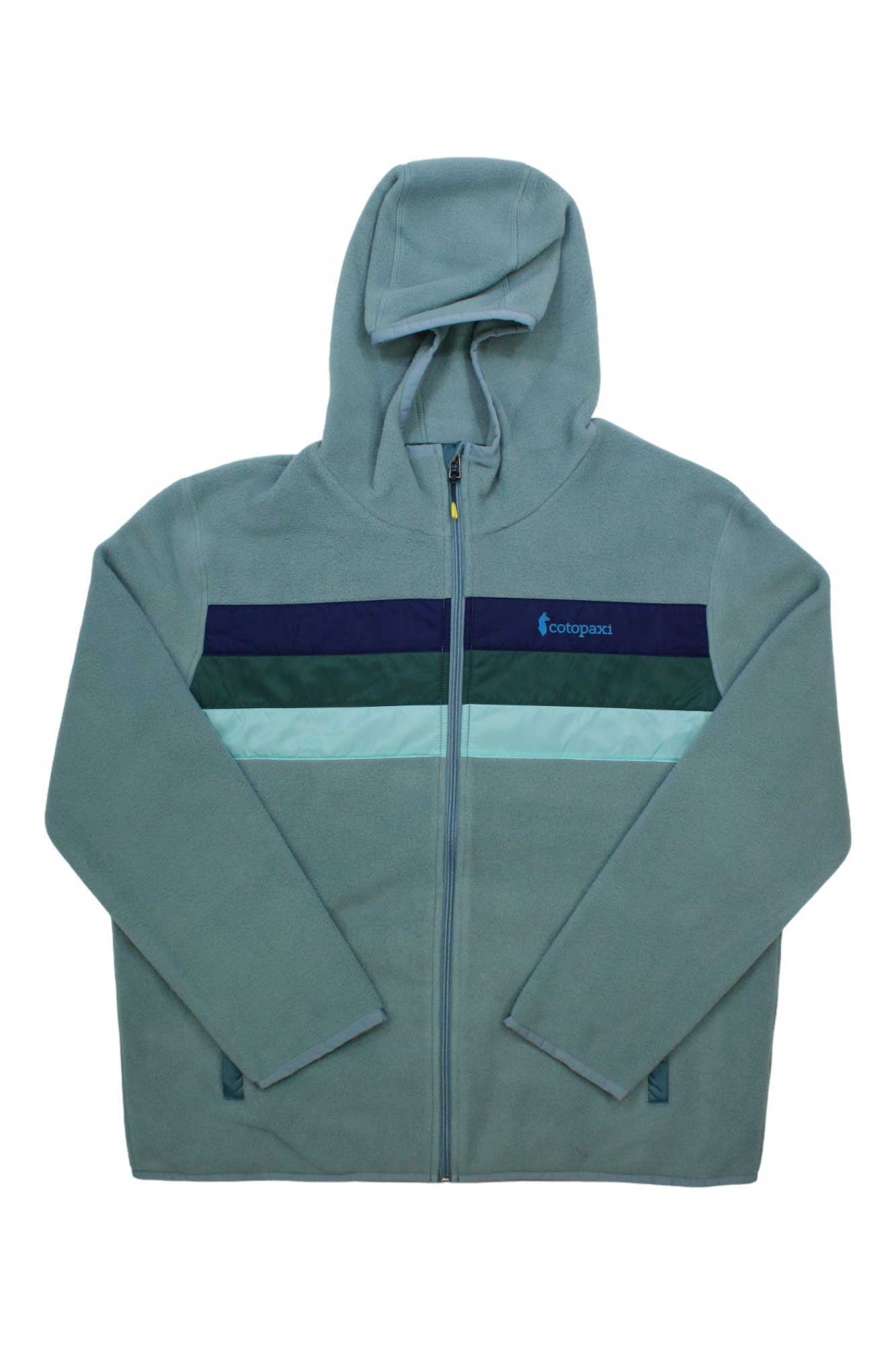 The Cotopaxi Womens Teca Fleece Hooded Full-Zip Jacket is light blue with dark blue and teal stripes, a left-chest logo, side pockets, long sleeves, recycled fleece fabric, and a cozy hooded full-zip design.