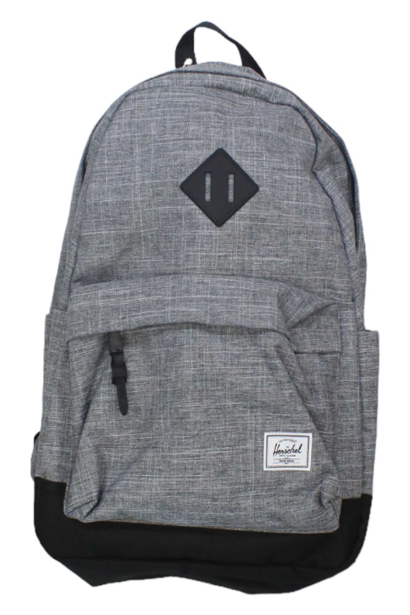 The Herschel Supply Company Heritage Backpack features a gray subtle plaid design, a black bottom, front zippered pocket, stitched black patch top center, small white label lower right, and is laptop compatible—ideal for travel.