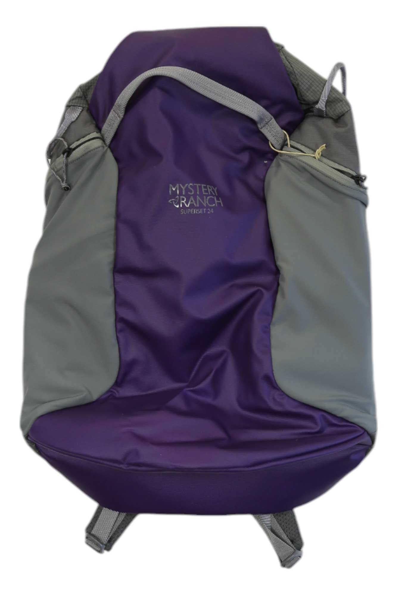 A gray and purple Mystery Ranch Superset 24 Backpack featuring the logo and SWEETPEA text on the front, displayed against a white background. This backpack includes side pockets, adjustable straps, and is perfect for hiking.