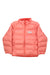 The Helly Hansen Kids Dalen Reversible Jacket in coral pink features a front zipper, high collar, and white HH logo on the chest. This stylish and functional outdoor jacket is perfect for kids' adventures.