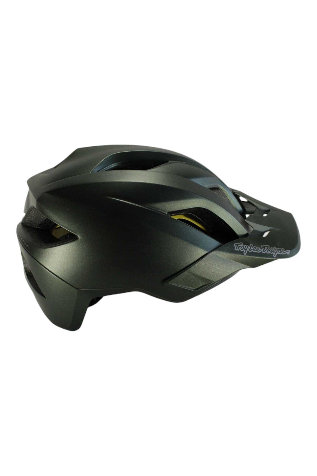 The Troy Lee Designs Flowline with MIPS Orbit Helmet, shown from a rear side angle, is a matte black MTB trail helmet featuring multiple air vents, a sleek aerodynamic design, and MIPS protection—perfect for mountain biking enthusiasts.