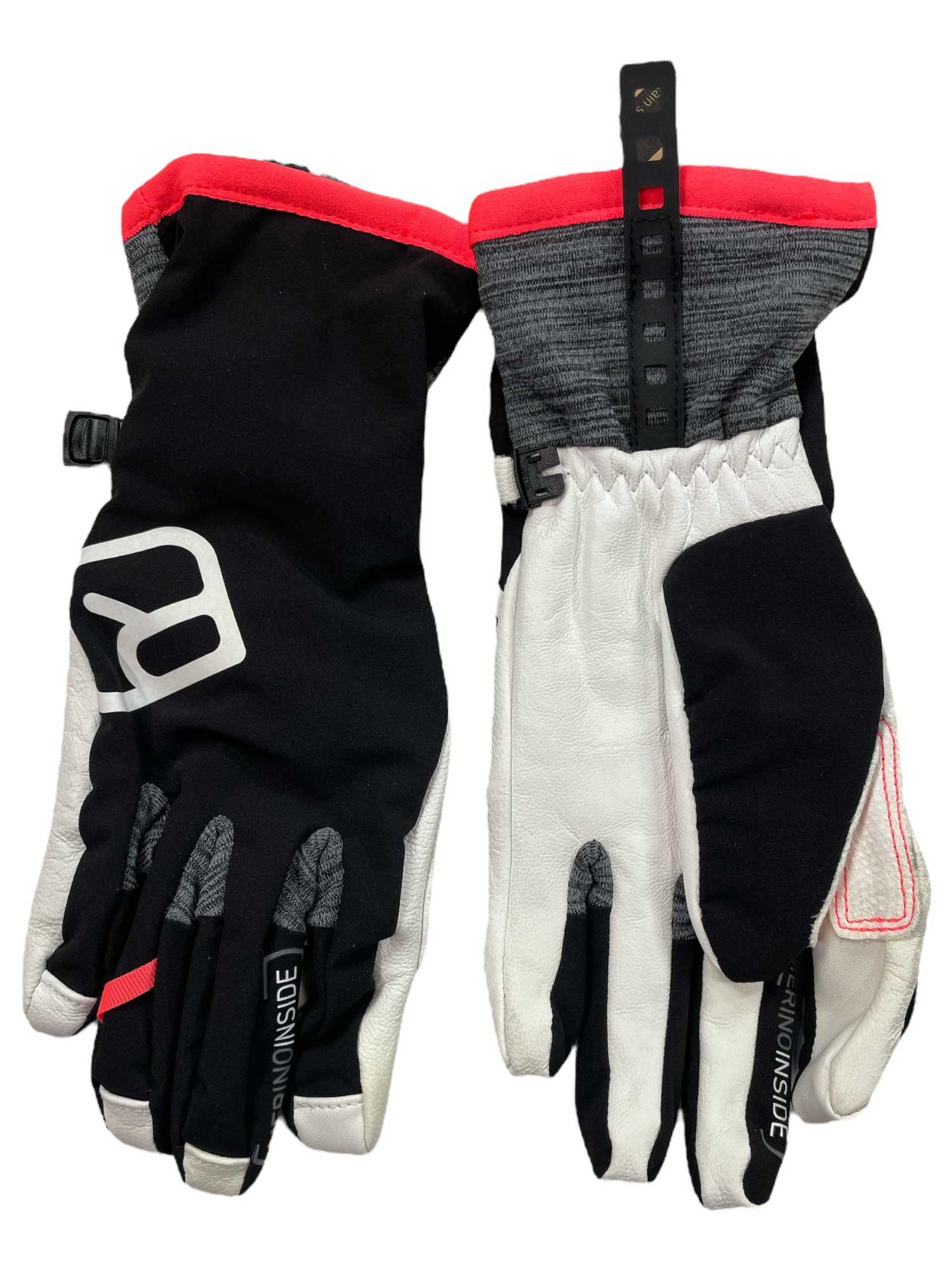 The Ortovox Womens Tour Glove is a pair of black, white, and gray mountaineering gloves with red trim, textured cuffs, water-resistant material, reinforced fingers, a logo on the back, and a hanging strap.