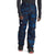 Wearing The North Face Mens Freedom Pant—dark pants featuring blue geometric patterns, water-resistant DryVent fabric, and a logo on one leg—paired with a long-sleeve shirt and black boots with red soles.