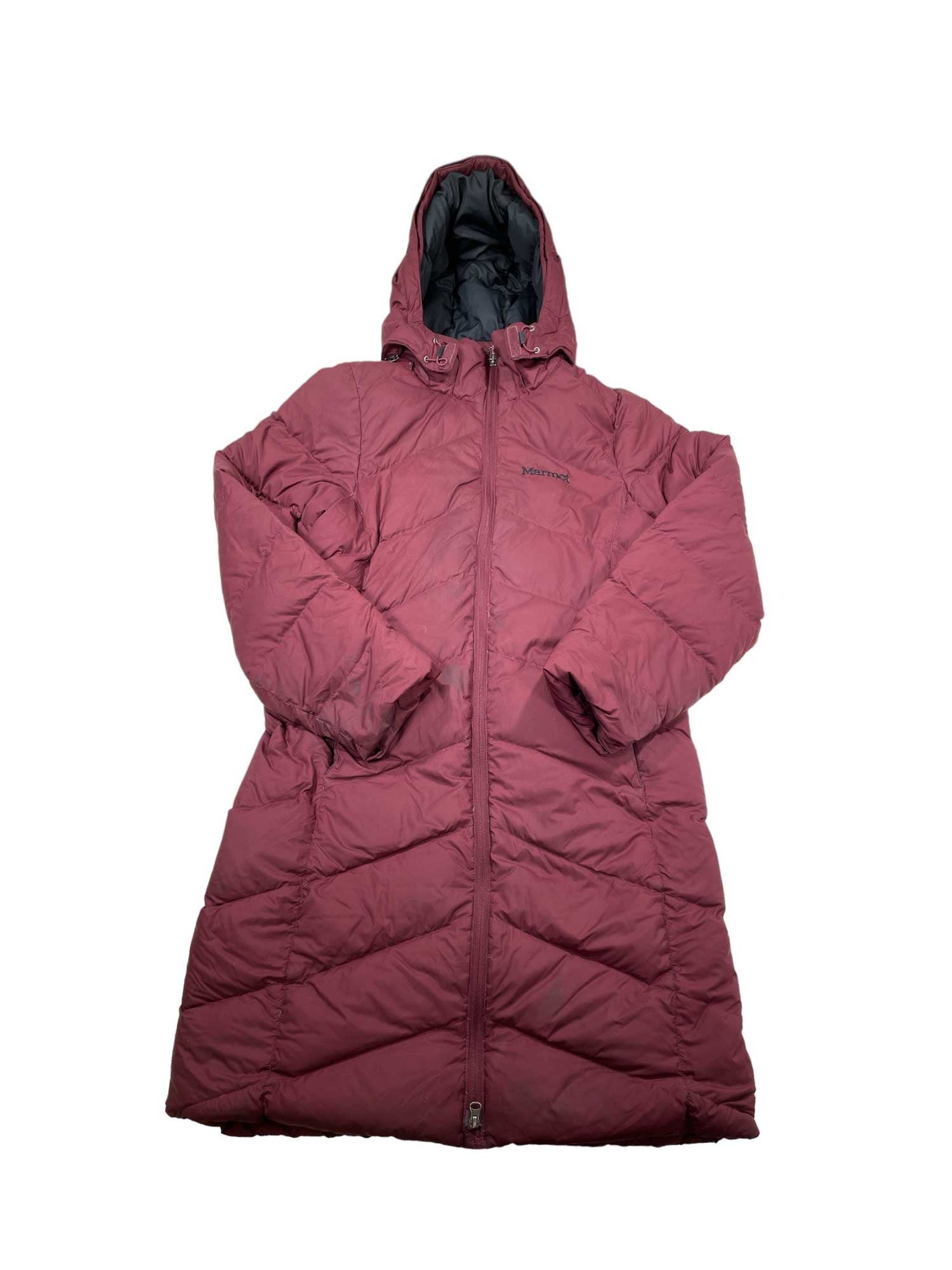 The Womens Montreaux Down Coat, a long maroon down coat with a hood, front zipper, and quilted design, offers warmth and style. This insulated coat is shown on a white background.