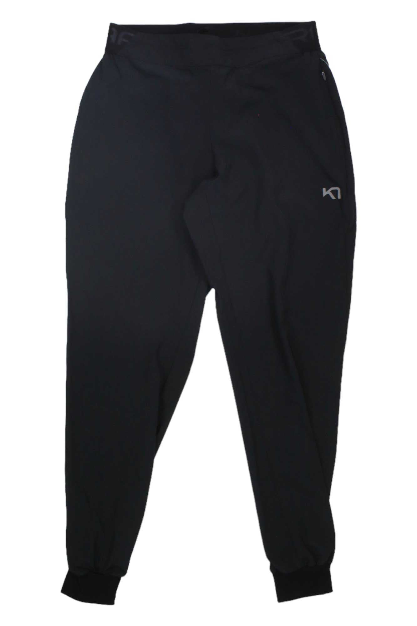 The Kari Traa Women's Nora 2.0 Pant features black athletic jogger style with elastic cuffs, waistband, and a small white K1 logo—ideal womens athleisure pants for workouts, travel, or hiking.