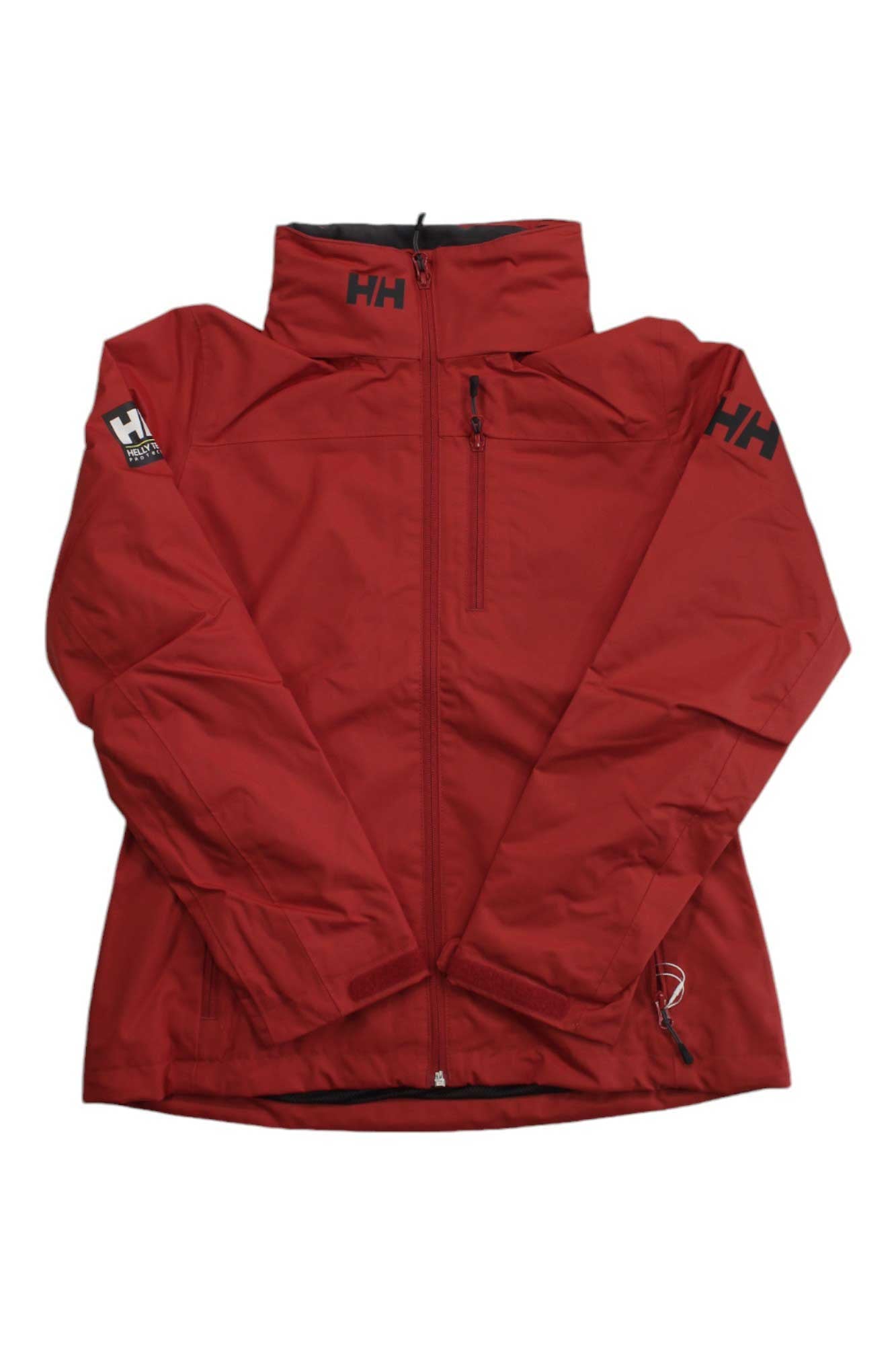 A red Helly Hansen Womens Crew Hooded Midlayer Jacket features a front zipper, high collar, black HH logos on the left chest, upper left sleeve, and right shoulder. It is shown laid flat with crossed sleeves.
