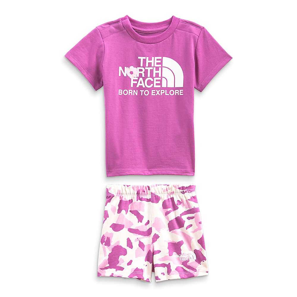 The North Face Infant Cotton Summer Set includes a purple “Born to Explore” tee and white shorts with a pink and purple camo print—a stylish, casual kids' outfit for summer.