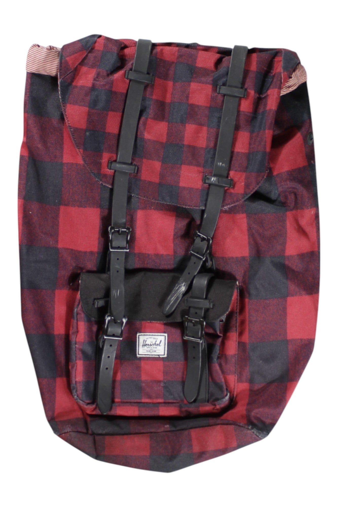 A red and black plaid Little America Backpack with black straps, a front pocket, padded laptop sleeve, white rectangular logo label, and a spacious 25L capacity.