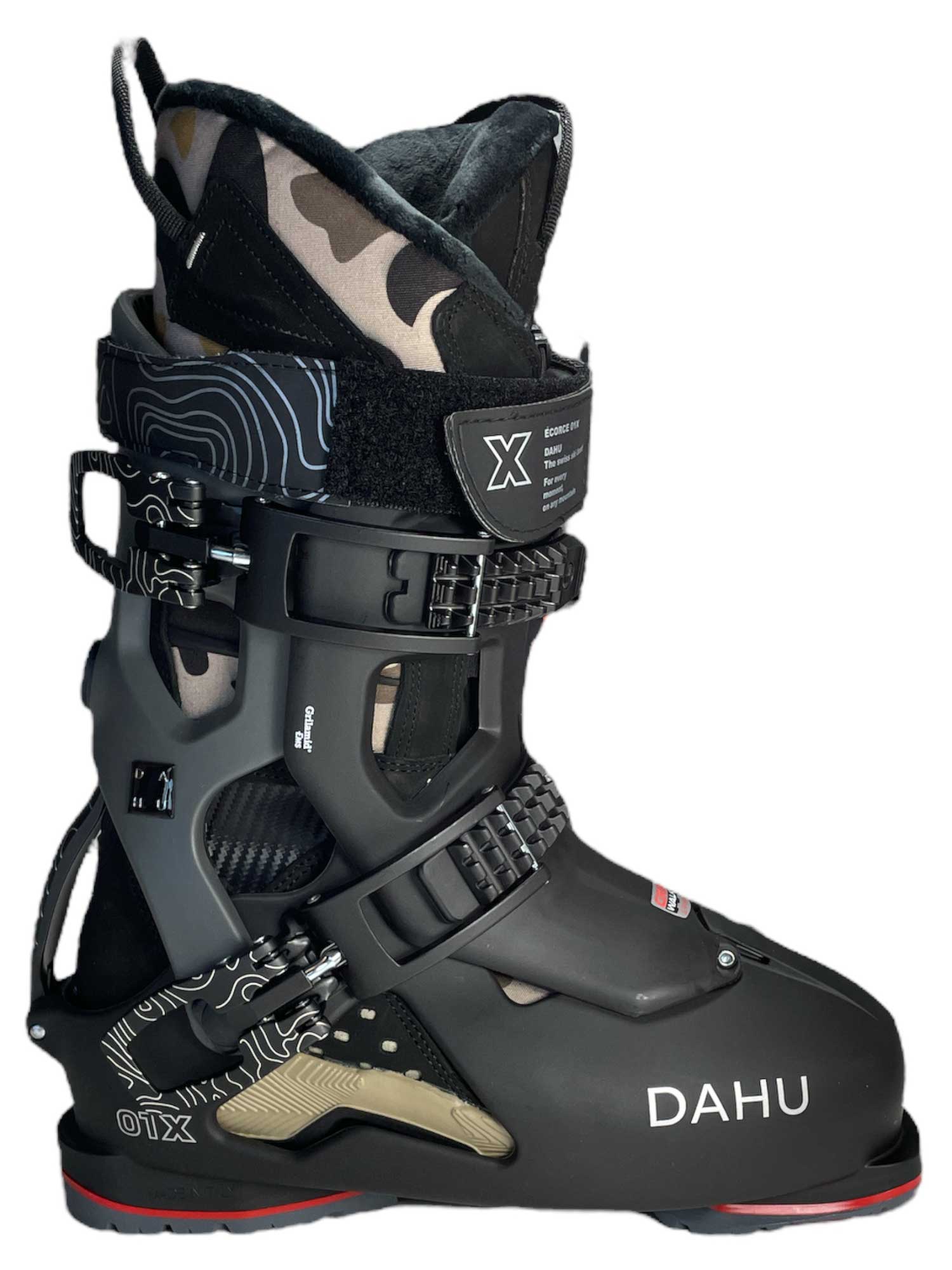The Dahu Mens Ecorce 01 X Limited Edition M120 Flex Ski Boot features a black design with three adjustable buckles, camouflage and geometric patterns, red sole accents, a high padded cuff, and the DAHU logo in white. Ships in the US.
