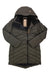 The Indyeva Womens Ayaba II Jacket in olive green features a quilted, water-resistant design with a hood, long sleeves, high collar, and front zipper. Shown flat on a hanger with tags attached.
