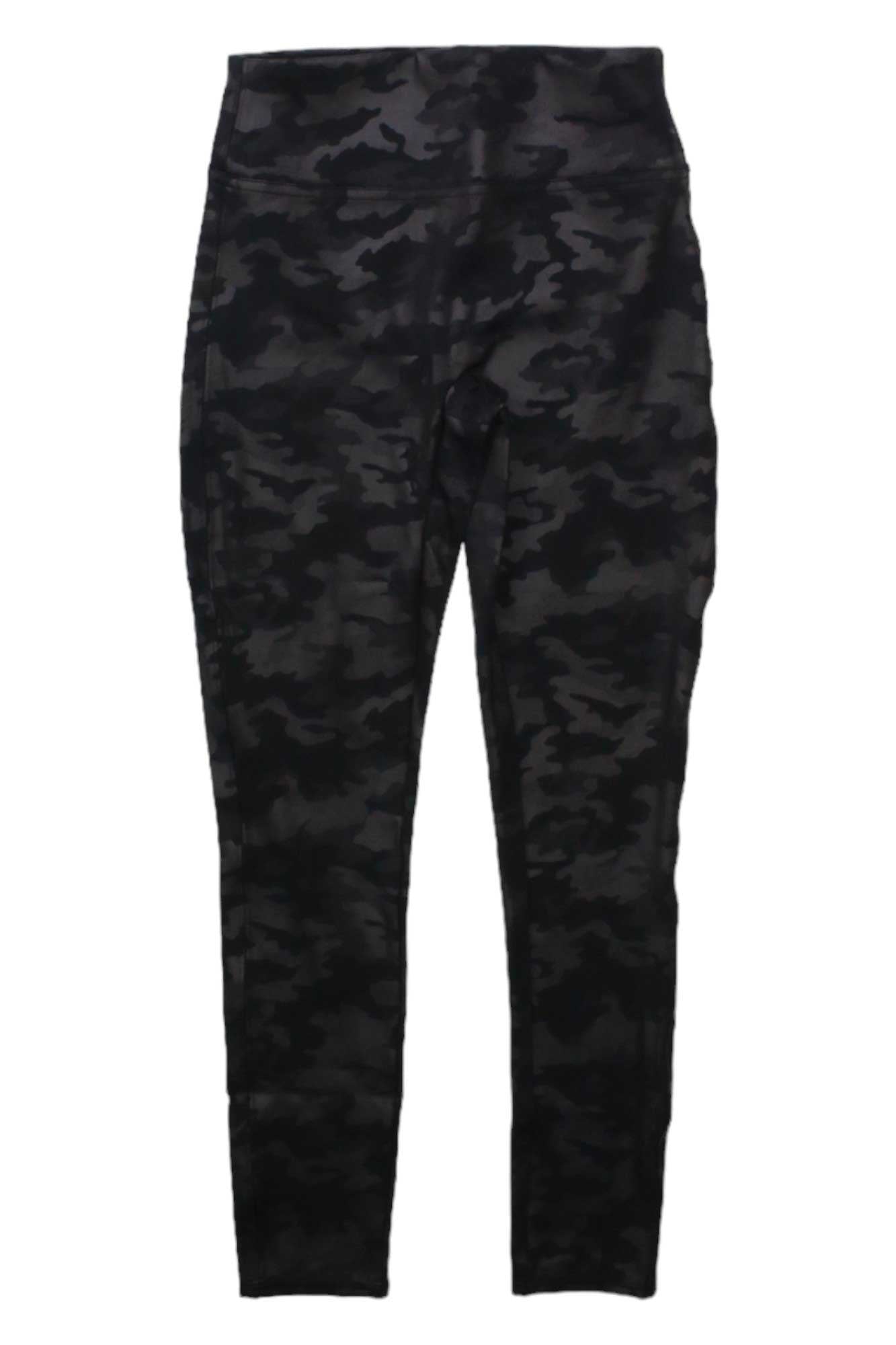 The Spanx Girl's Faux Leather Star Legging is shown laid flat on a white background, featuring a trendy black and dark gray camouflage print inspired by classic Spanx style.