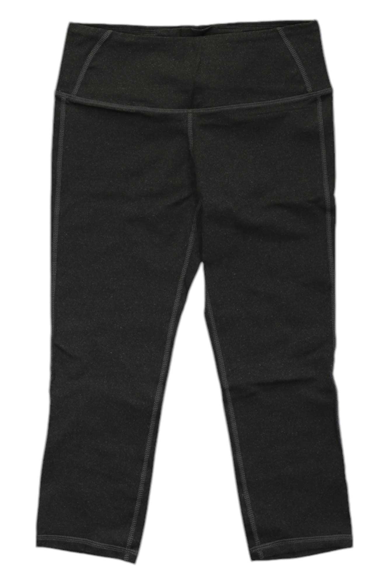 A pair of Stonewear Designs Womens Liberty Tight Capri leggings in black, featuring moisture-wicking fabric, a wide waistband, and visible seam stitching, laid flat on a white background.