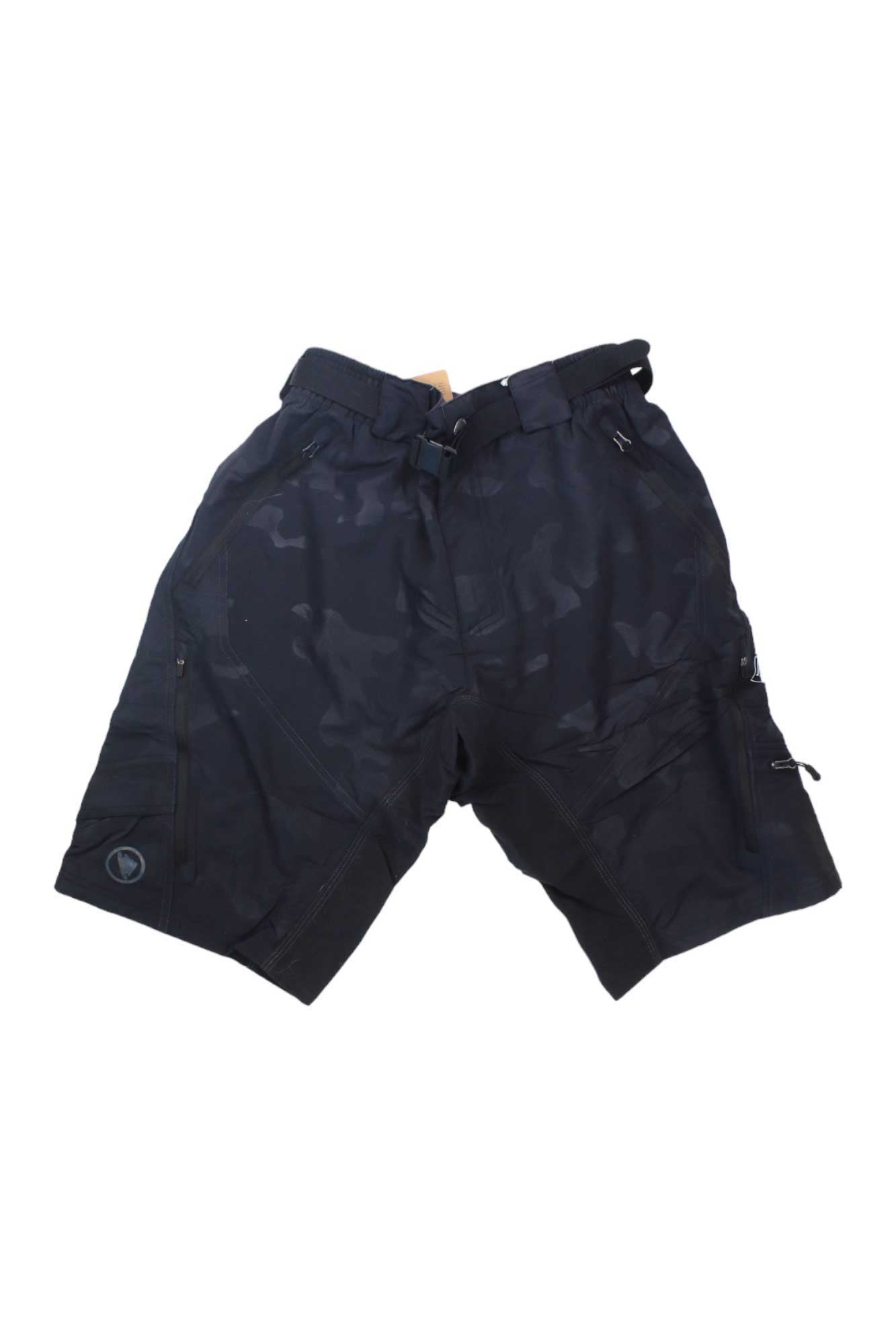 The Endura Mens Hummvee Short II in black camo is made from durable nylon, features multiple zippered pockets and an integrated belt—ideal for mountain biking. Shown laid flat on a white background.
