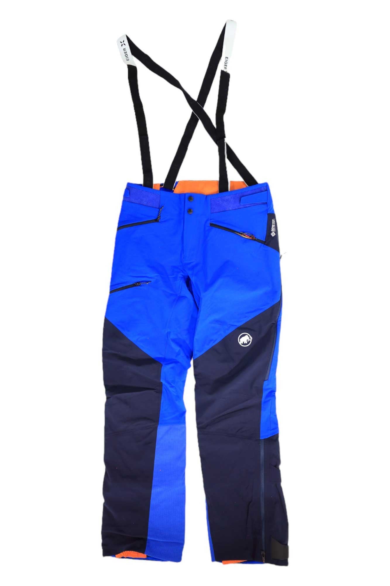 The Mammut Mens Eisfeld Guide SO Pant features bright blue and navy soft shell fabric, black adjustable suspenders, zippered pockets, reinforced knees, an orange Gore-Tex Infinium lining at the waistband, and a logo on the thigh.