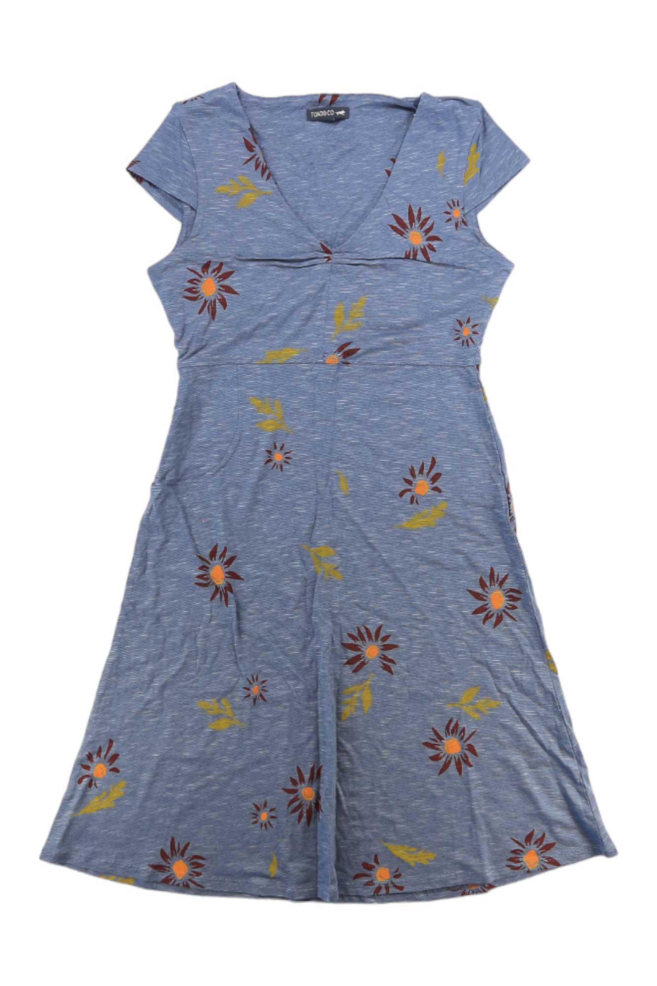 The Toad & Co Women's Rosemarie Dress is a short-sleeved, knee-length blue organic cotton dress with a V-neck and red, yellow, and white floral print. This eco-friendly, relaxed-fit dress is displayed flat on a white background.