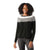 A woman with curly hair smiles while wearing the Smartwool Womens Edgewood Colorblock Crew Sweater in black, gray, and white. She stands facing forward against a plain white background with one arm relaxed at her side.