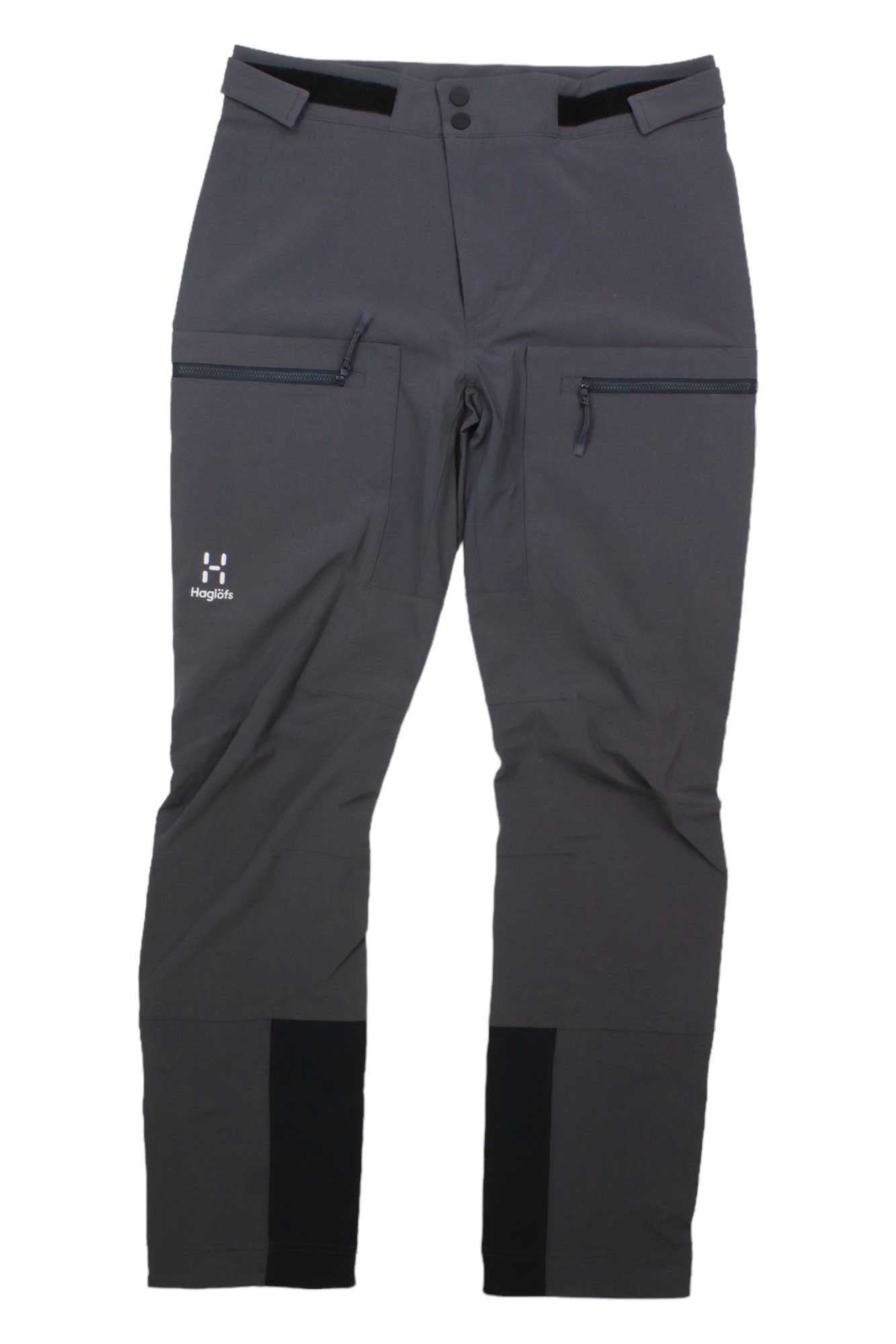 The Haglofs Mens Roc Sight Softshell Pant is a dark gray mountaineering pant featuring zippered pockets, reinforced knees, and the Haglöfs logo on the left thigh.