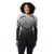 A woman with curly hair smiles wearing the Smartwool Womens Intraknit Thermal Merino Base Layer Pattern Crew and black leggings, standing against a white background.